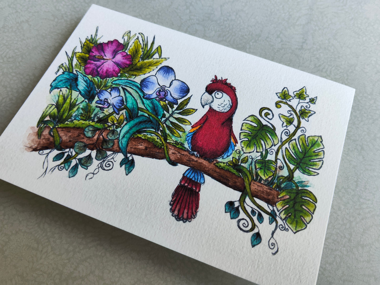Carte A6 Oiseau Perroquet Ara sur branche fleurie – Aquarelle nature