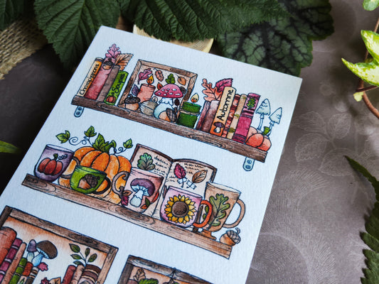 Carte Bibliothèque Automnale – Livres, Citrouilles et Maisons Douillettes